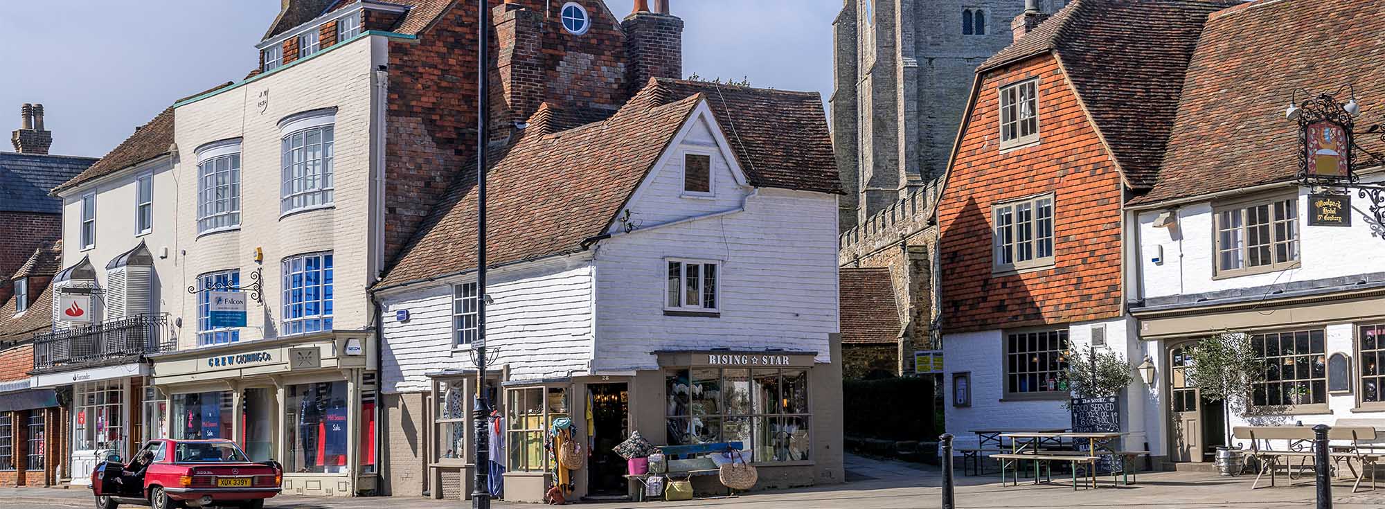 A sunny photo of Tenterden high street in Kent, it's packed with independent shops and cafes, a popular place for weekend breaks.