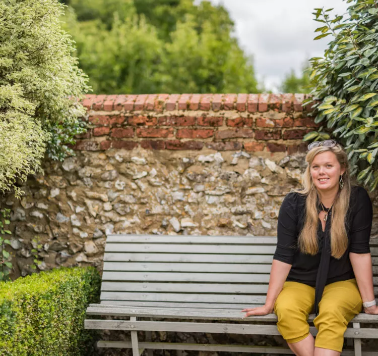 Rowena Owen, a co founder of Bloom Stays, sat on a bench at Dormestone Farm in the summer.