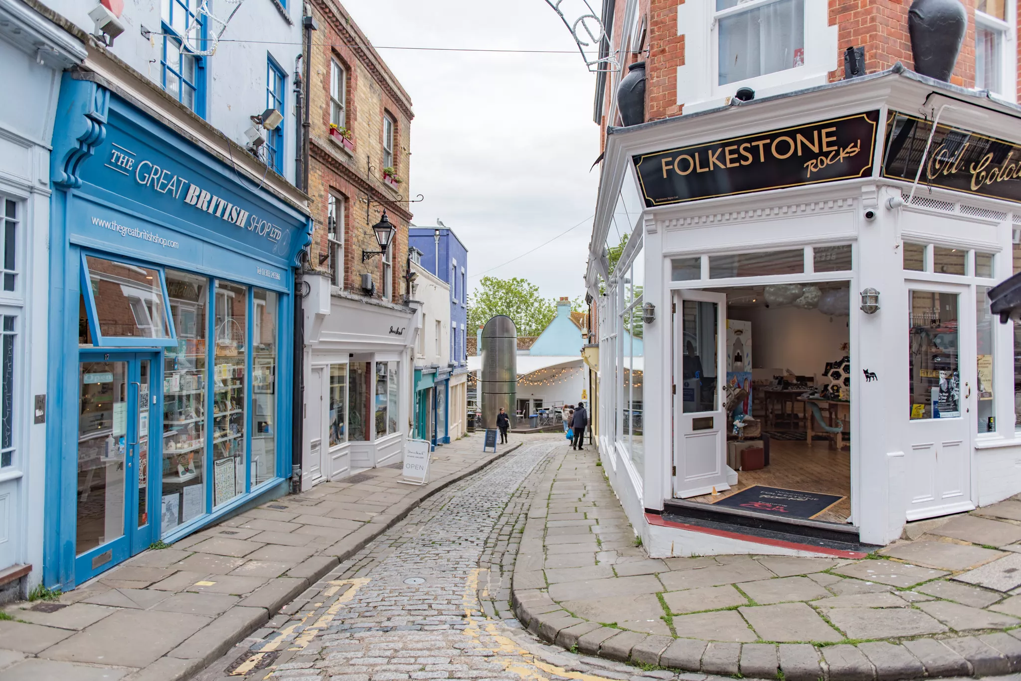 The narrow high street in Folkestone, Kent filled with local independent shops.
