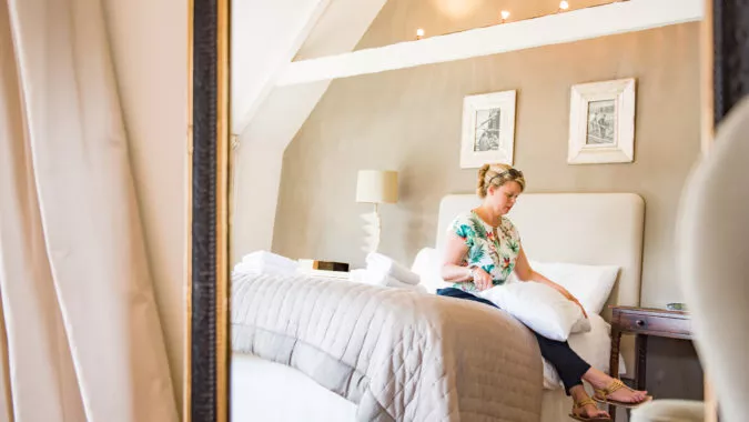 Rowena Owen, a co founder of Bloom Stays, plumping the cushions at Dormestone Farm