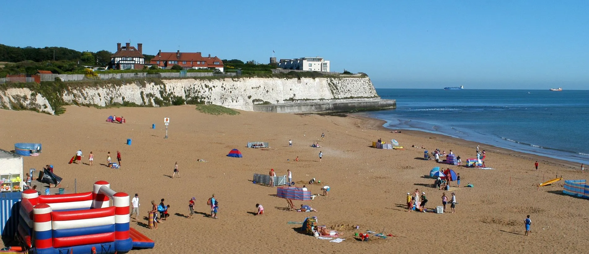 A sunny photo of people enjoying the weather on the beach in Broadstairs, Kent.