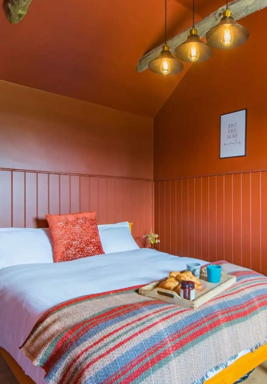 The vibrant terracotta bedroom at Challenger, McCanns Brewery