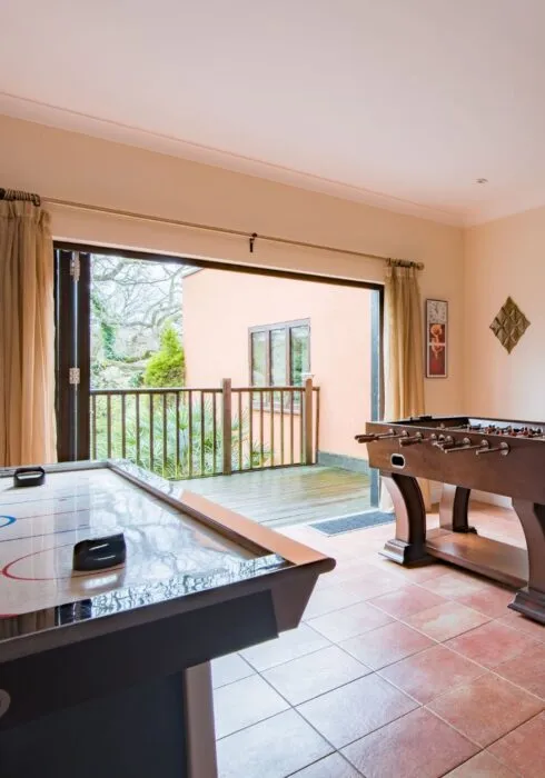 Air hockey and foosball tables at the Honeywood Lodge games room, Canterbury