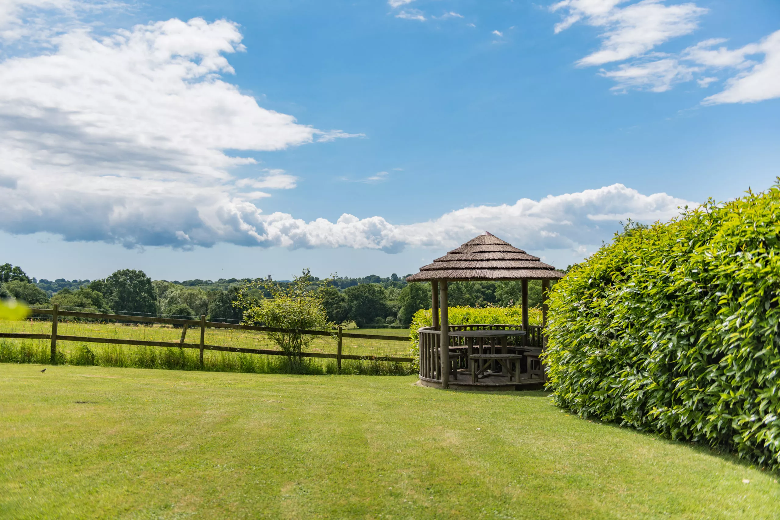 The large, sunny gardens at Lower Standen Farm in Kent, offering a picnic area with views over looking the countryside.
