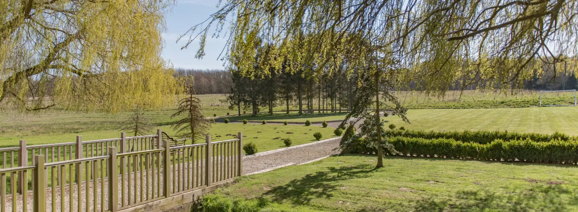 A view of the large gardens at Honeywood Lodge, a holiday home in Canterbury, Kent