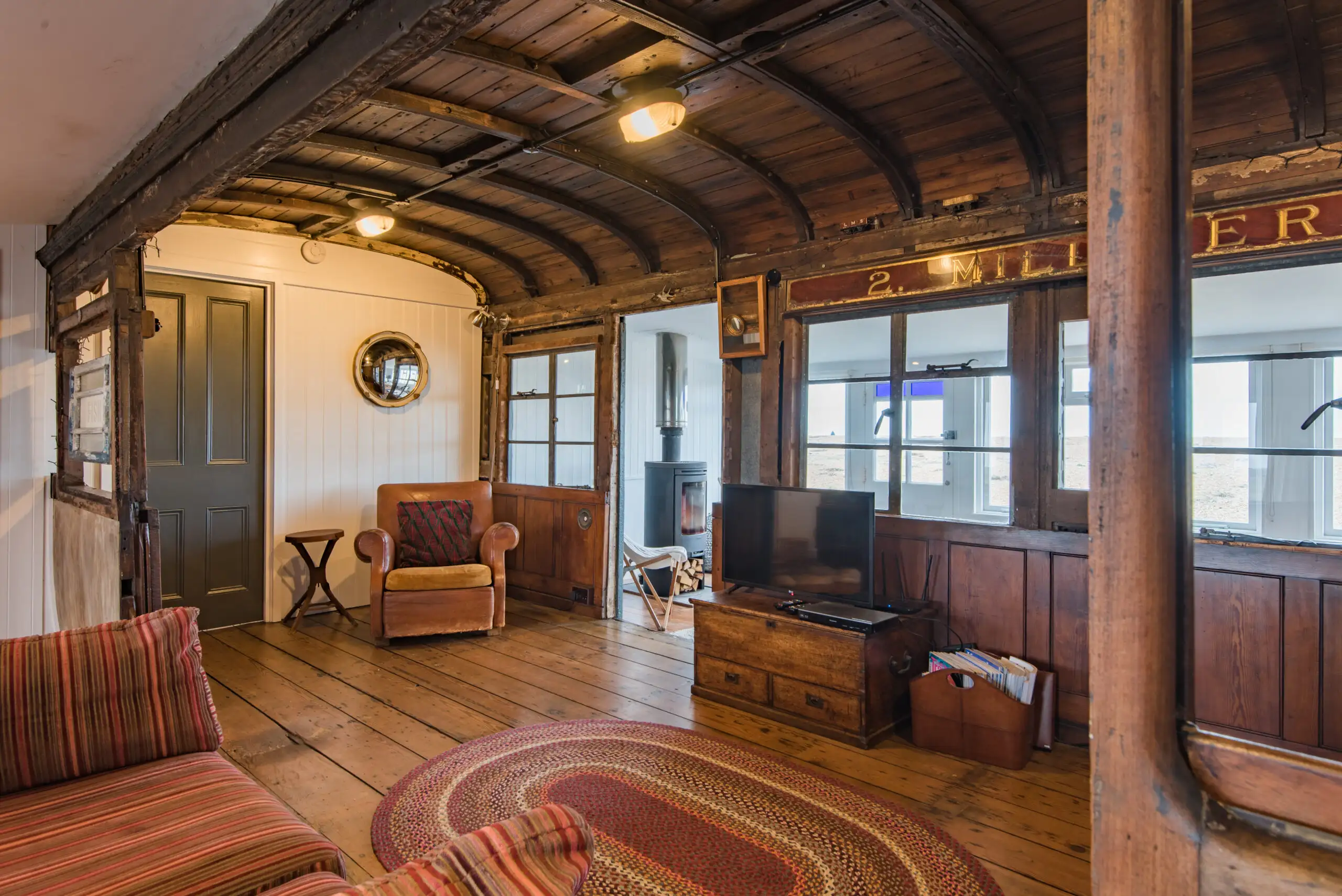 The inside of Sunray, a Dungeness Holiday Home that has an old railway carriage running through the living room.