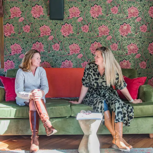 Rowena and Nicky, co founders of Bloom Stays, sat on a sofa Lower Standen Farm, a holiday home in Kent