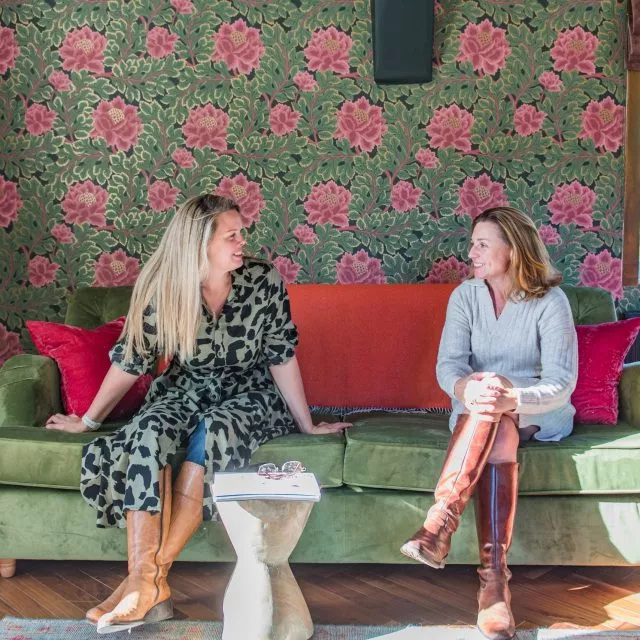 Rowena and Nicky, co founders of Bloom Stays, sat on a sofa Lower Standen Farm, a holiday home in Kent