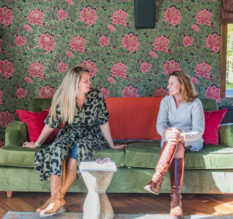 Rowena and Nicky, co founders of Bloom Stays, sat on a sofa Lower Standen Farm, a holiday home in Kent