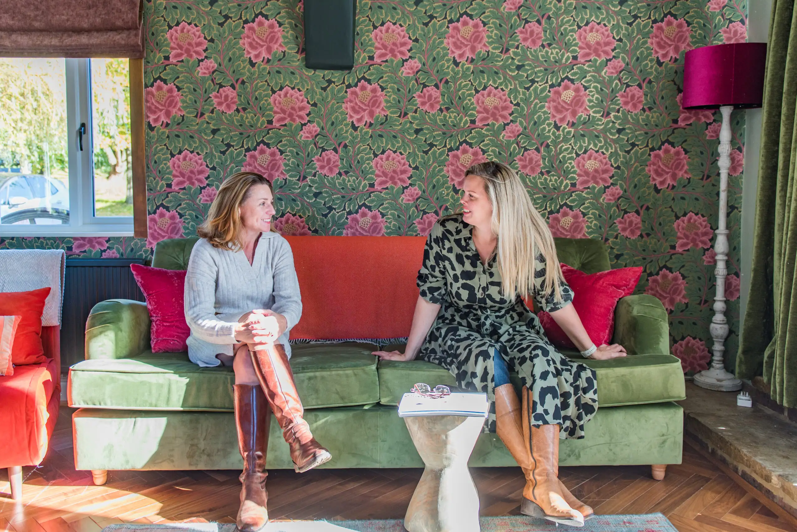 Rowena and Nicky, co founders of Bloom Stays, sat on a sofa Lower Standen Farm, a holiday home in Kent