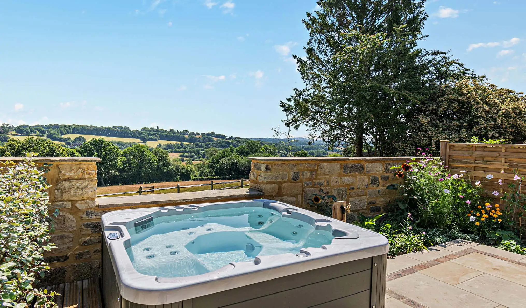 Wide blue skies and countryside views from the hot tub at Dairy Barn, a holiday home near Tunbridge Wells