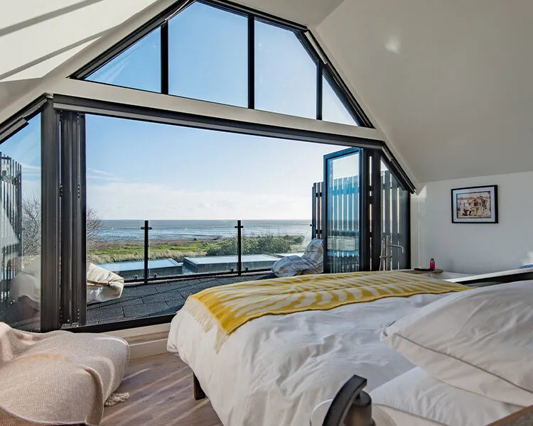 A very sunny sea view from the top floor bedroom at Waters Edge, a large holiday home in Greatstone Kent