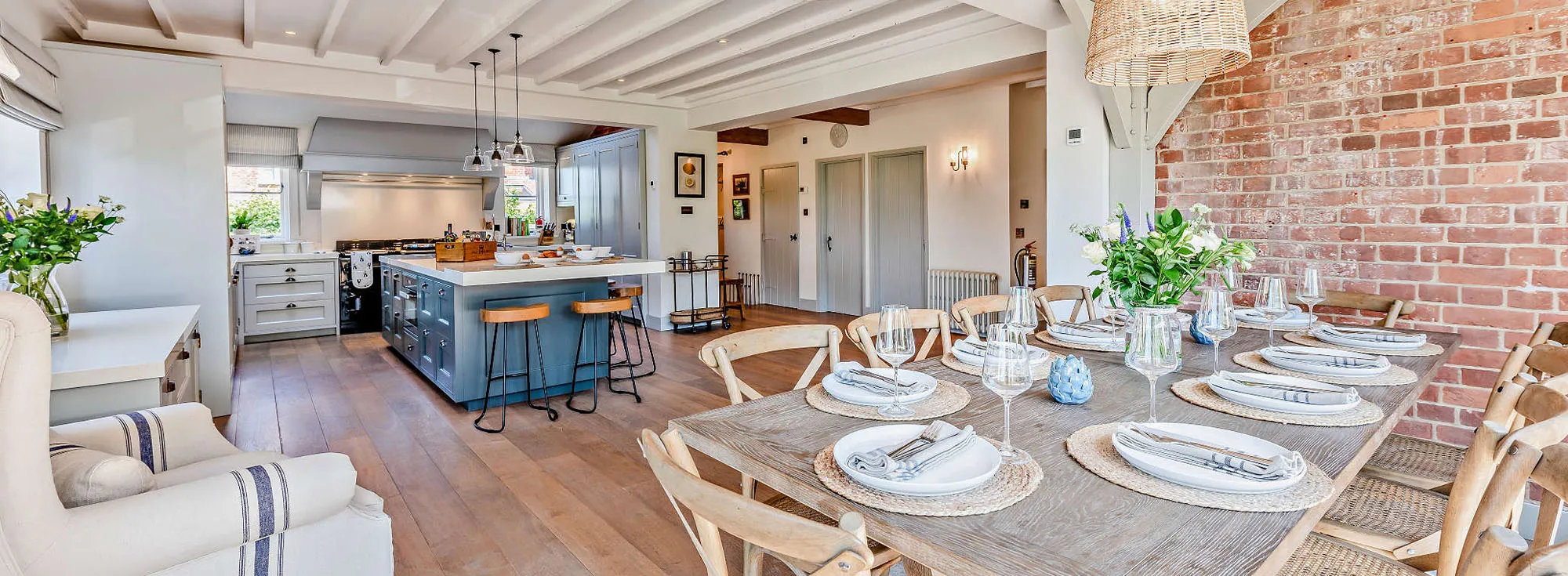 Bedgebury Oast holiday home in Kent, with an exposed brick wall and large open plan kitchen area.