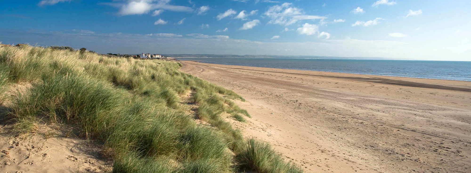 The wide empty beach at Greatstone in Kent, a popular place for seaside family holidays.