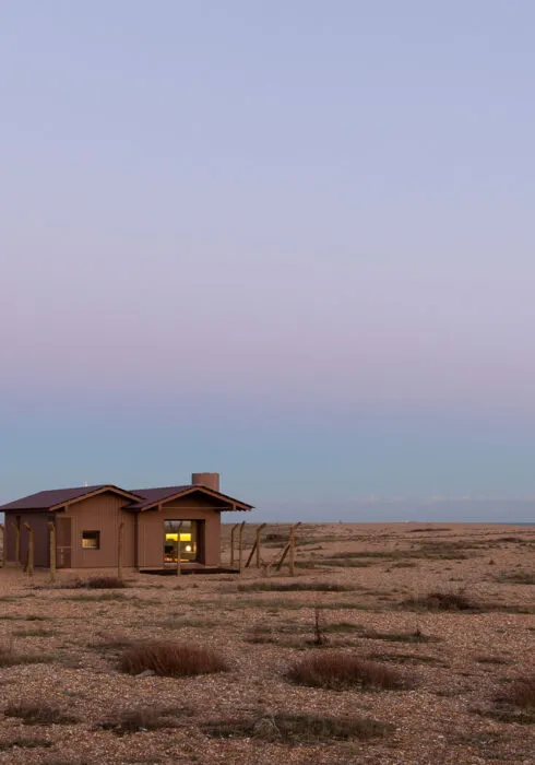 A beautiful capture of the sun sunsetting in Dungeness with Radar, a holiday home, in the centre.