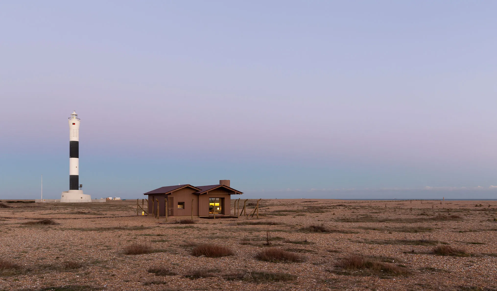 A beautiful capture of the sun sunsetting in Dungeness with Radar, a holiday home, in the centre.