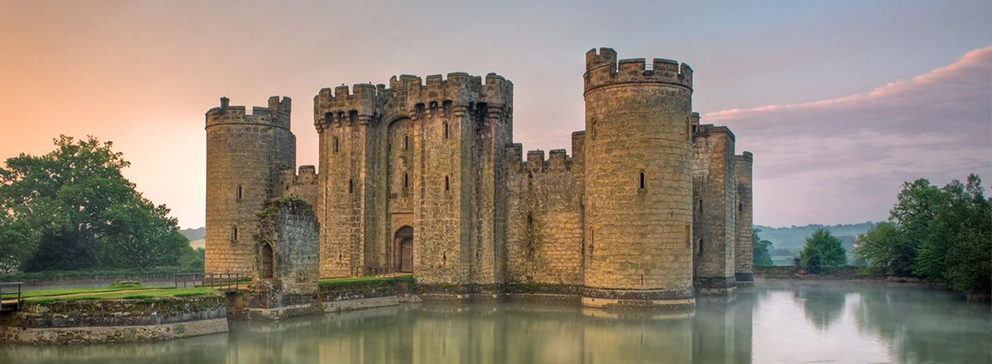 A beautiful photo of the sun rising behind the castle in Staplecross, Sussex.
