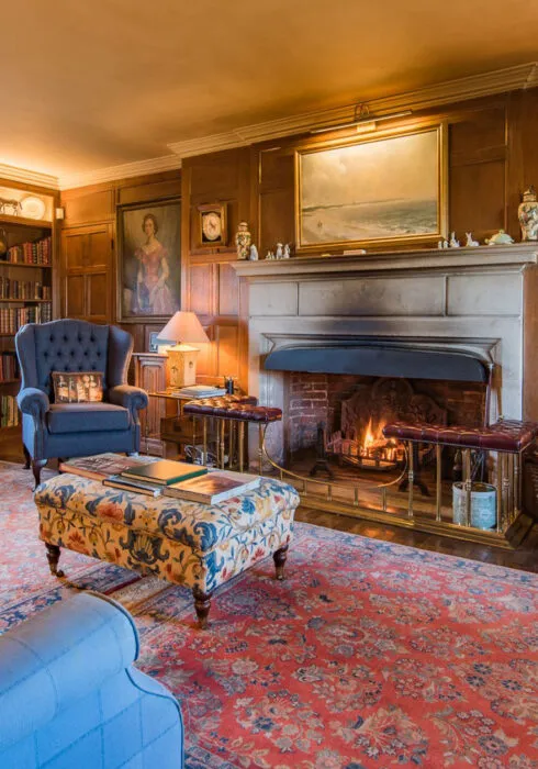Open lit fire in the living room of Beadles, a period holiday home in Sandwich