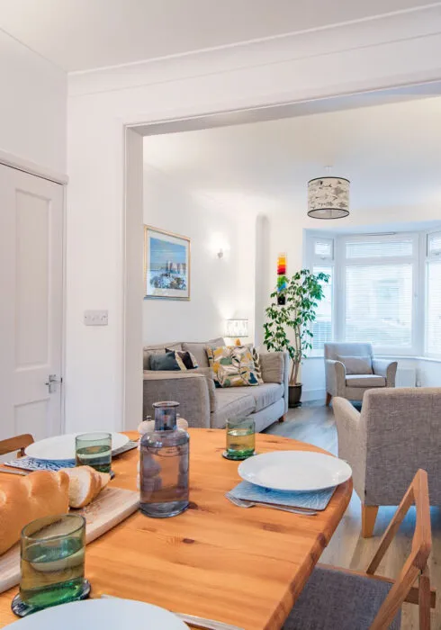 The living room table set up for dinner at Samphire Cottage in Broadstairs
