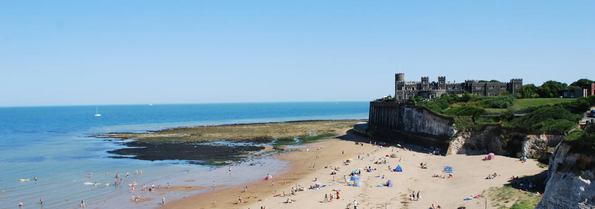 People sunbathing on the sandy beach at Joss Bay in Broadstairs