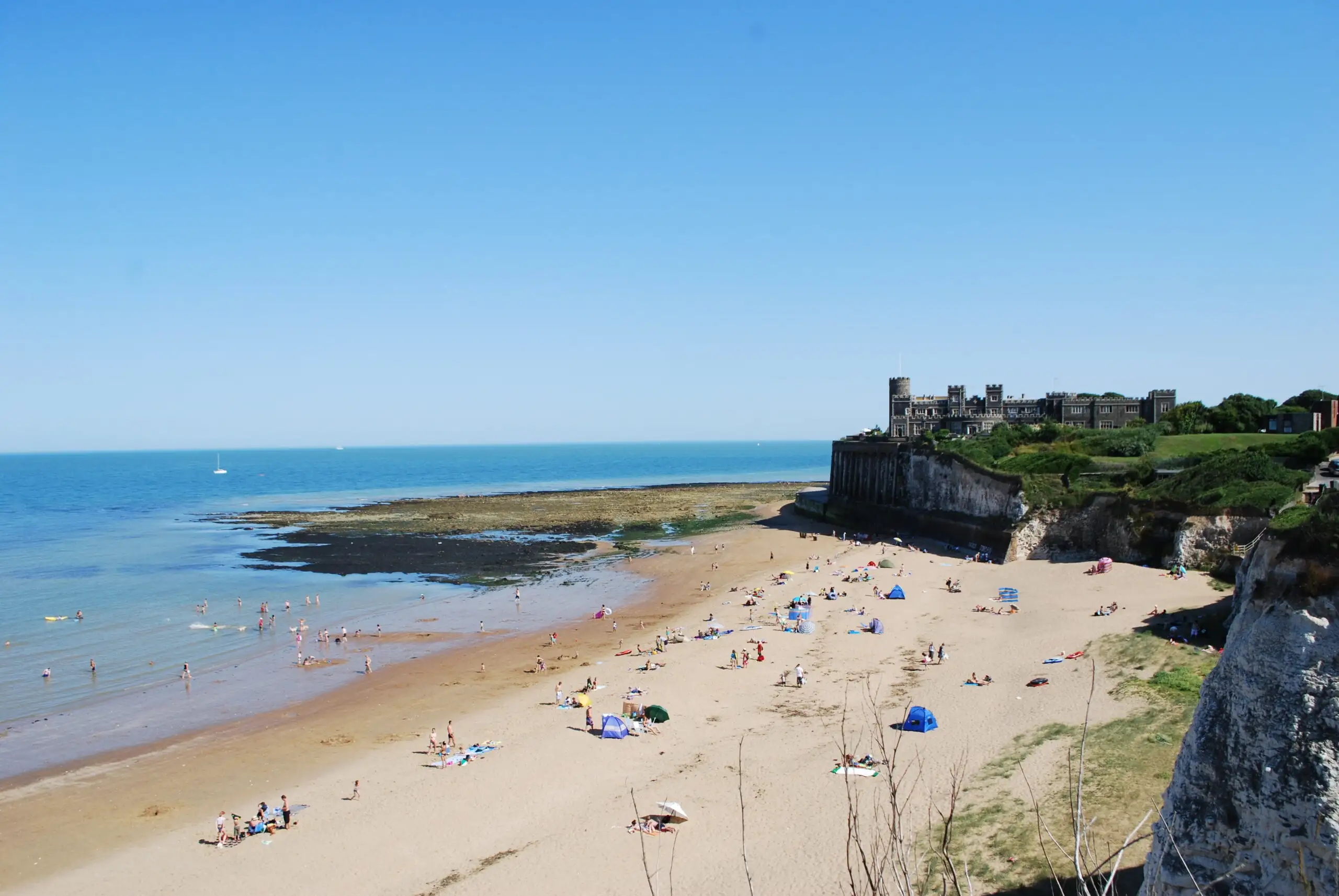 People sunbathing on the sandy beach at Joss Bay in Broadstairs