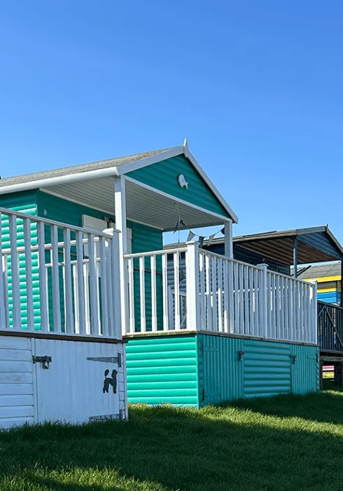 Colourful beach huts and blue skies at Whitstable seafront