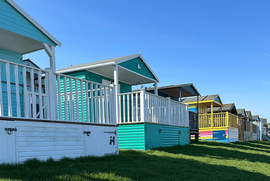 Colourful beach huts and blue skies at Whitstable seafront