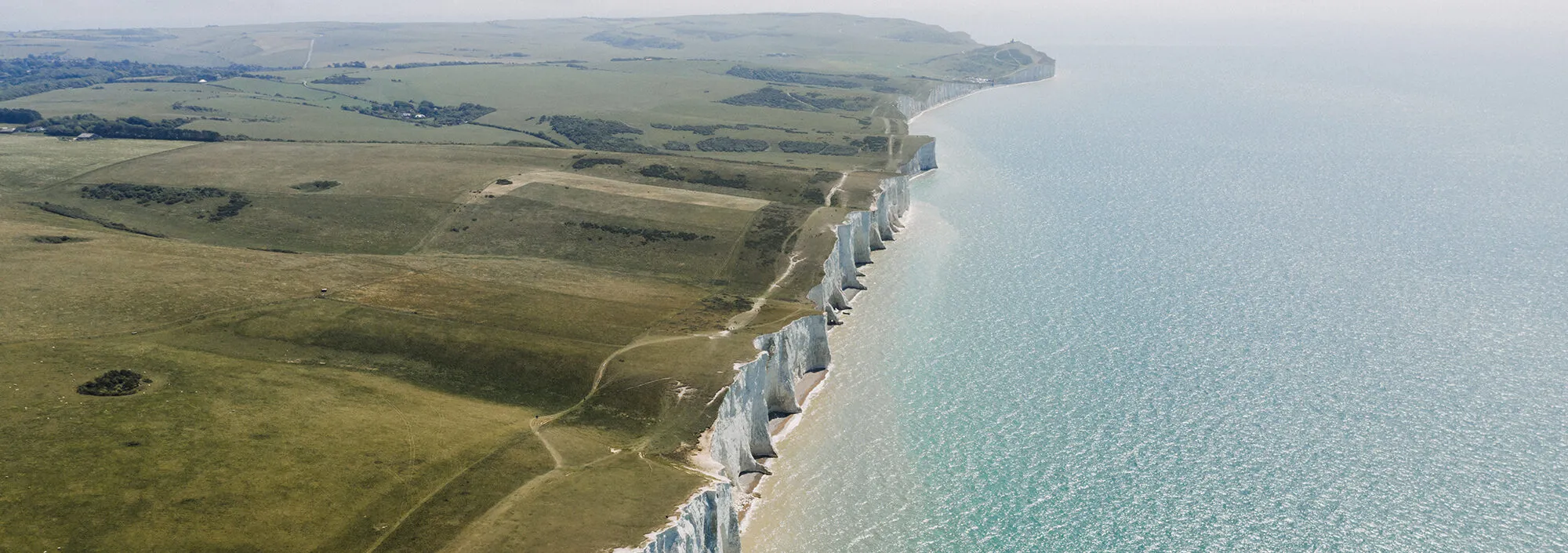 Wide open shot of St Margaret's Bay, capturing the white cliffs and far reaching sea views