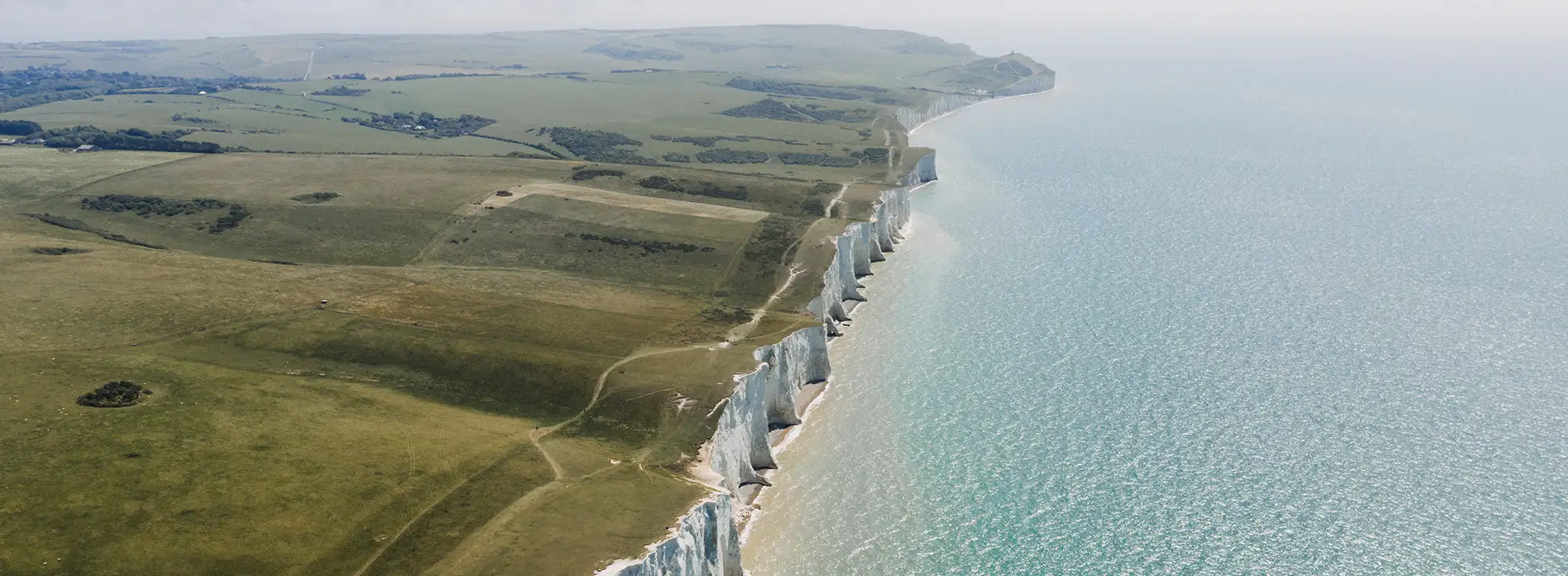 Wide open shot of St Margaret's Bay, capturing the white cliffs and far reaching sea views