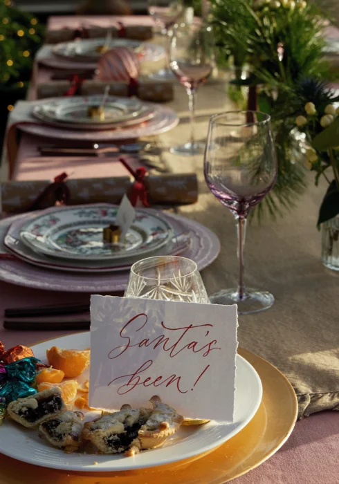 A decorated table for Christmas and a 'Santa has been' message on a plate