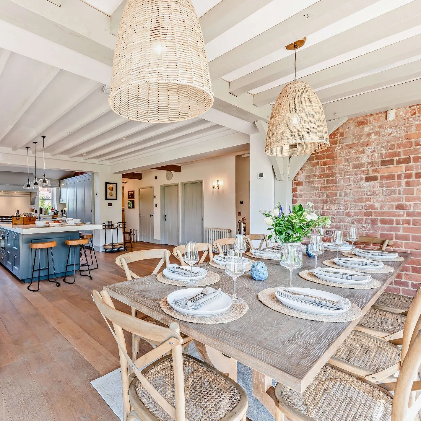 Open kitchen and dining room with rattan furniture at Bedgebury Oast, nr Tunbridge Wells