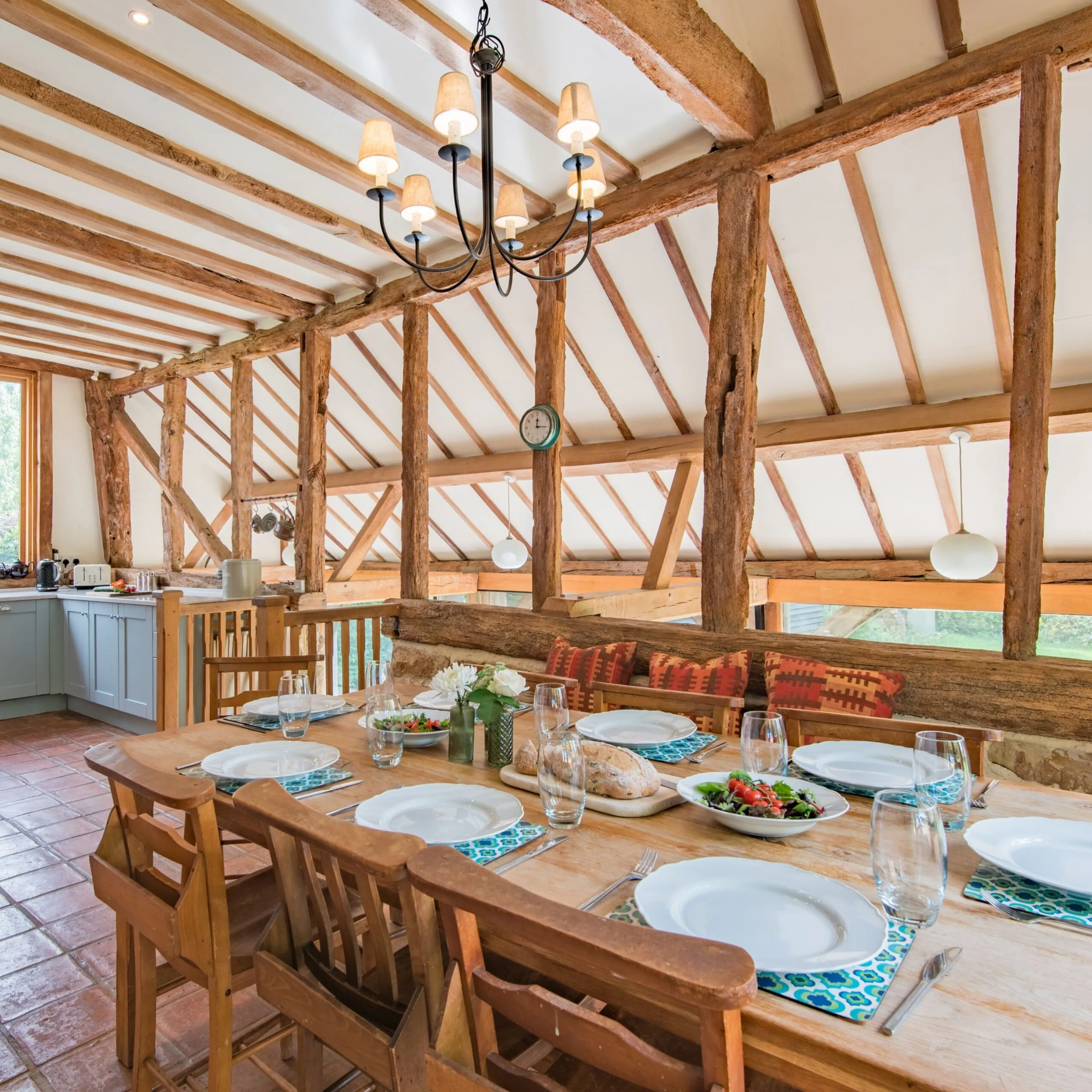 Beautiful wooden beam adorned dining room and kitchen, at Masketts Barn in Nutley, East Sussex