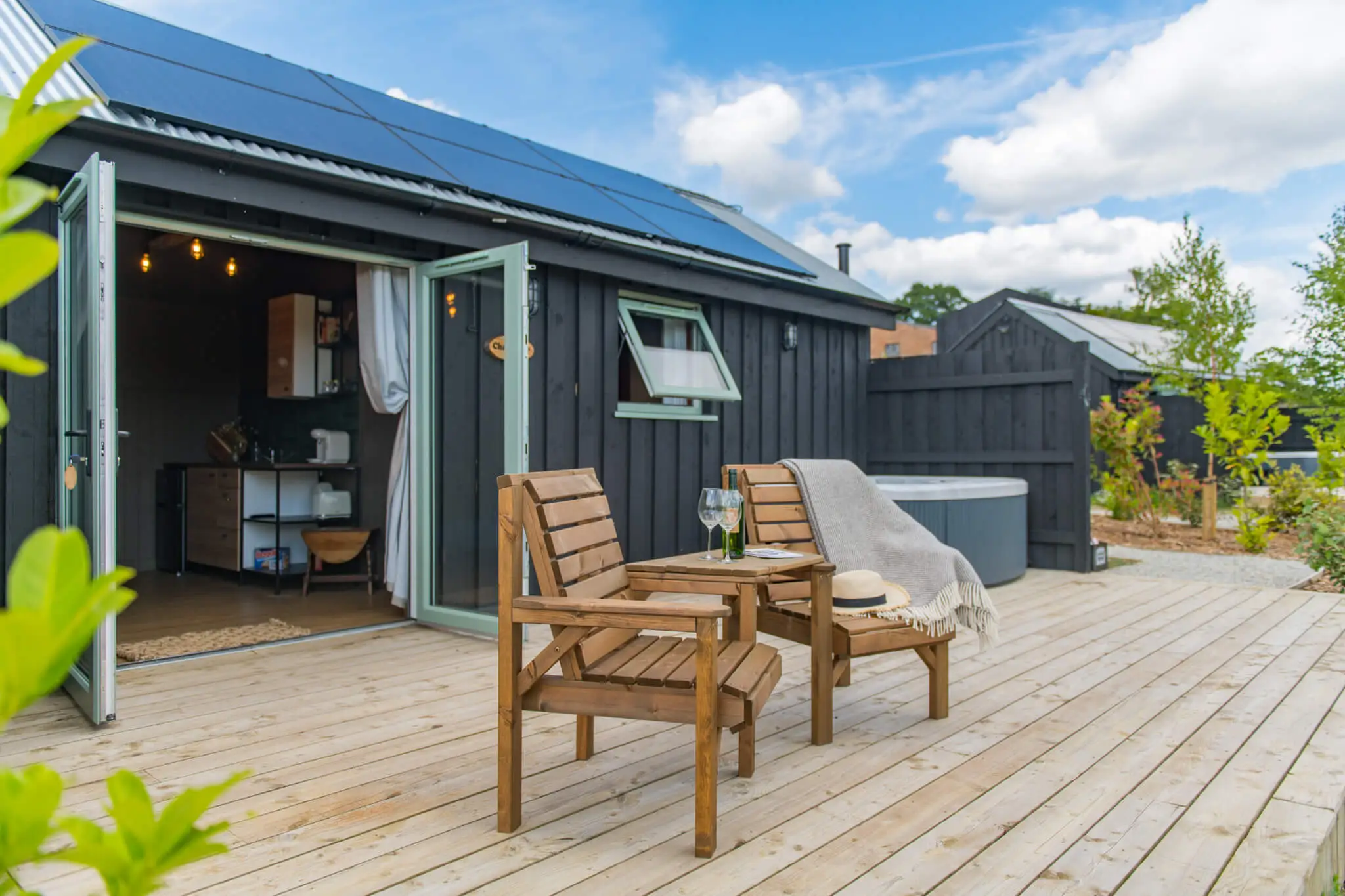 The private decking area and hot tub at Challenger, a cabin set on the grounds of McCann's Brewery in Kent